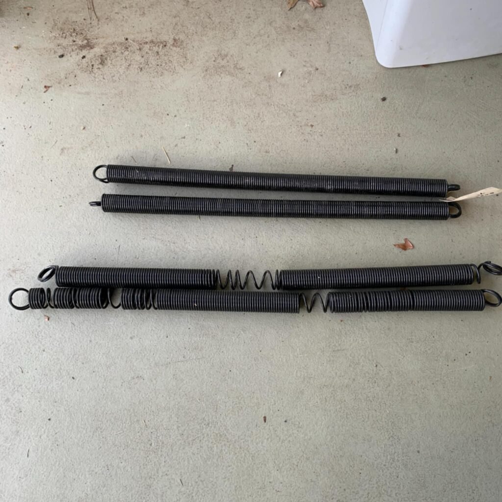 Removed broken garage door torsion springs before replacement by Ben Garage Doors LLC